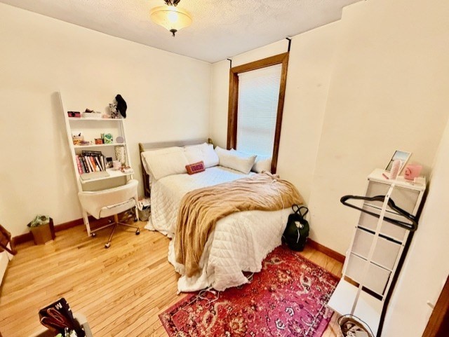 11 Foster Street, Unit 5 Boston, MA 02109 - Photo 17 of 19 a bedroom with a bed and wooden floor