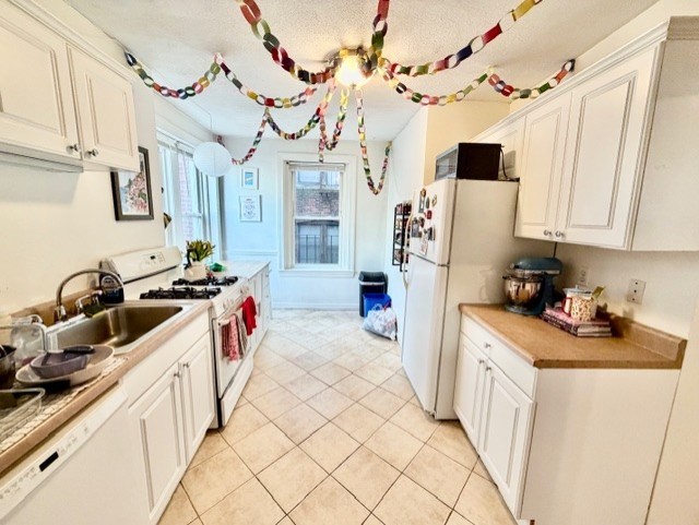 11 Foster Street, Unit 5 Boston, MA 02109 - Photo 2 of 19 a kitchen with stainless steel appliances a sink a stove a refrigerator and cabinets