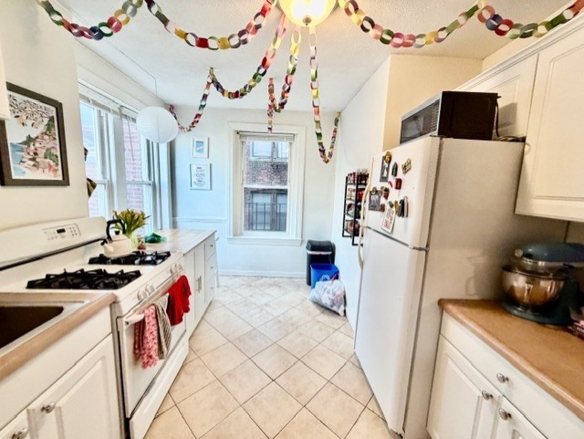 11 Foster Street, Unit 5 Boston, MA 02109 - Photo 3 of 19 a kitchen with stainless steel appliances a stove a refrigerator and a sink