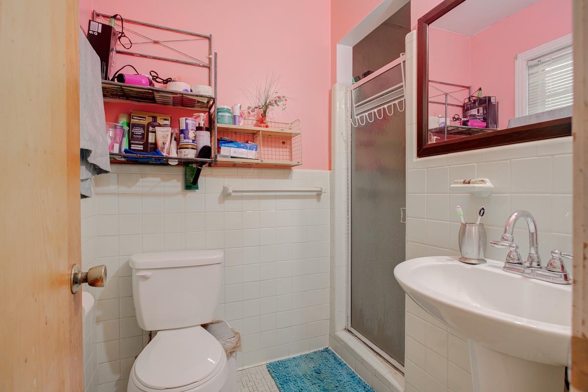 1019 Tatum Road Memphis, TN 38122 - Photo 14 of 21 Bathroom with a shower stall, a wainscoted wall, and tile walls