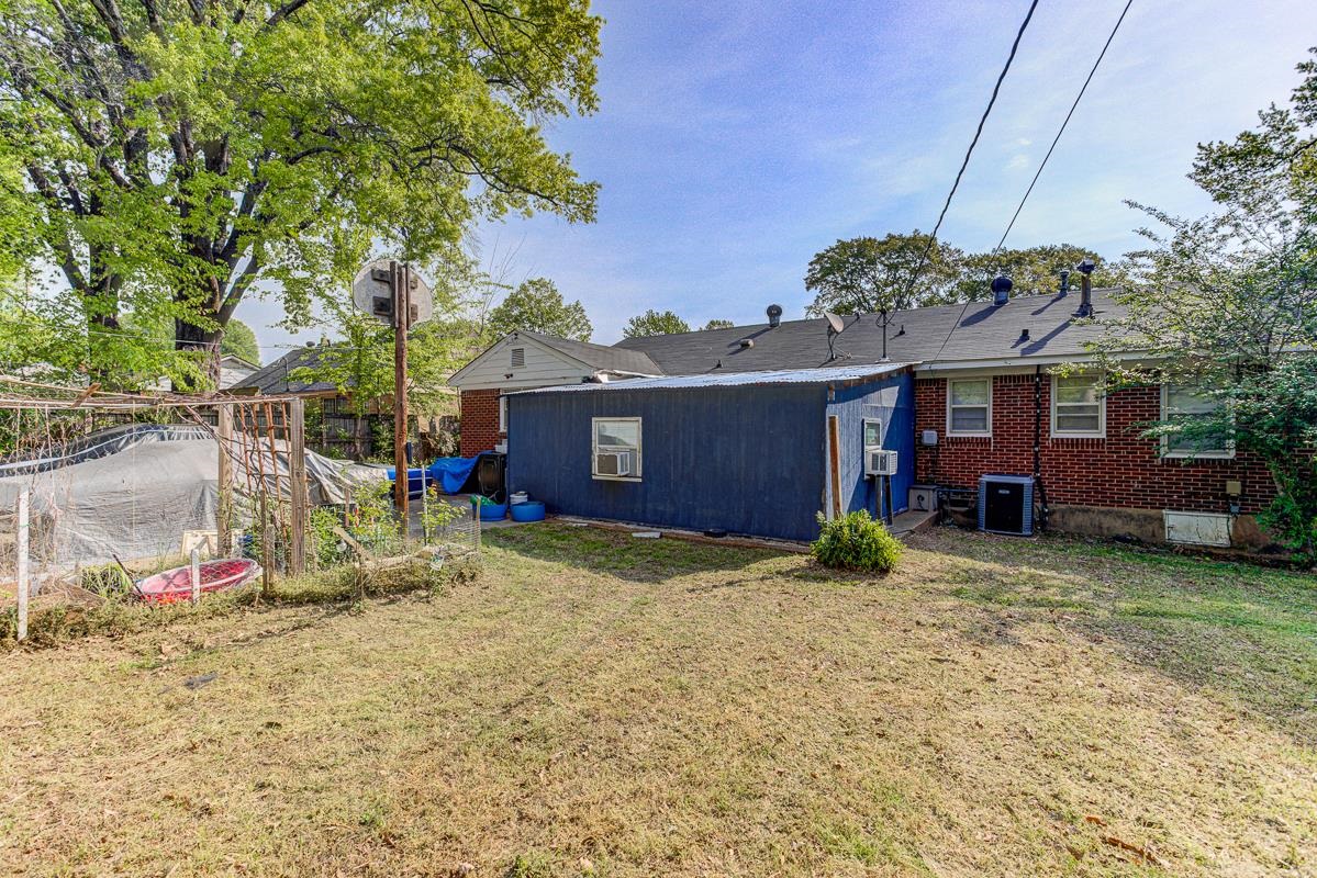 1019 Tatum Road Memphis, TN 38122 - Photo 20 of 21 Back of property with a yard and brick siding