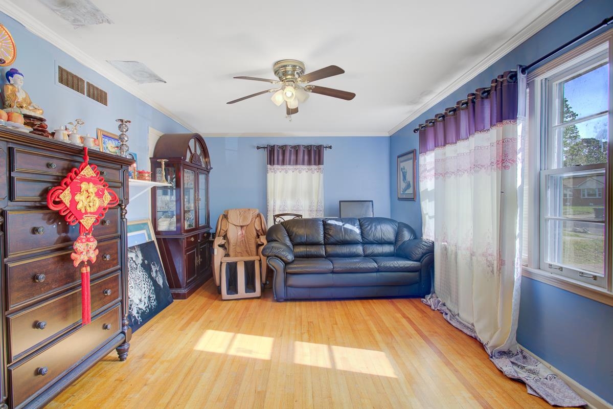 1019 Tatum Road Memphis, TN 38122 - Photo 2 of 21 Living room featuring light wood finished floors, ceiling fan, and ornamental molding