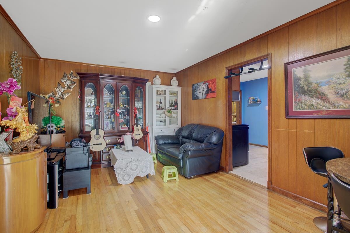 1019 Tatum Road Memphis, TN 38122 - Photo 3 of 21 Sitting room featuring wood walls, light wood-type flooring, and ornamental molding