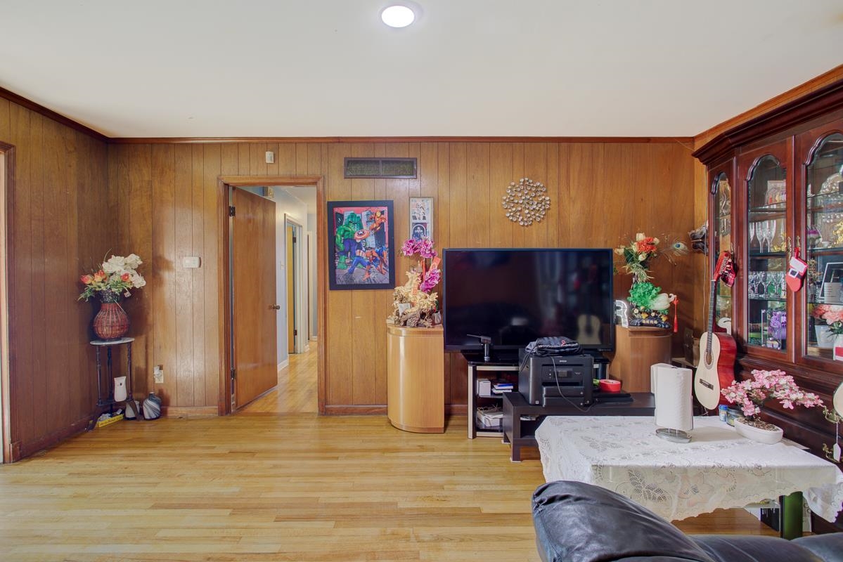 1019 Tatum Road Memphis, TN 38122 - Photo 4 of 21 Living area with light wood-style flooring, wooden walls, recessed lighting, and crown molding