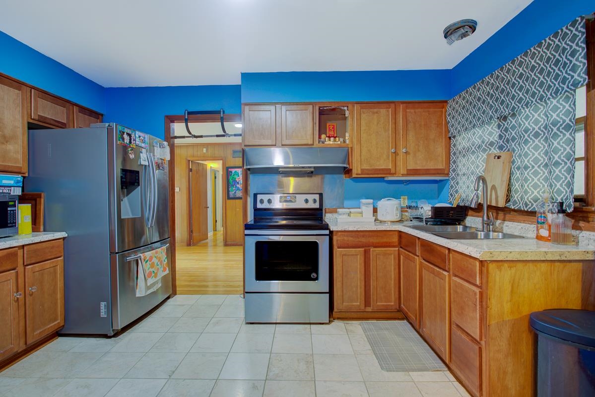 1019 Tatum Road Memphis, TN 38122 - Photo 6 of 21 Kitchen featuring stainless steel appliances, light countertops, wood finish cabinetry, and open shelves