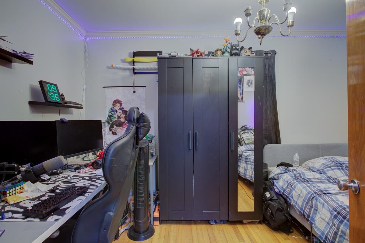 1019 Tatum Road Memphis, TN 38122 - Photo 7 of 21 Bedroom featuring light wood-type flooring, an office area, suspended lighting, and crown molding