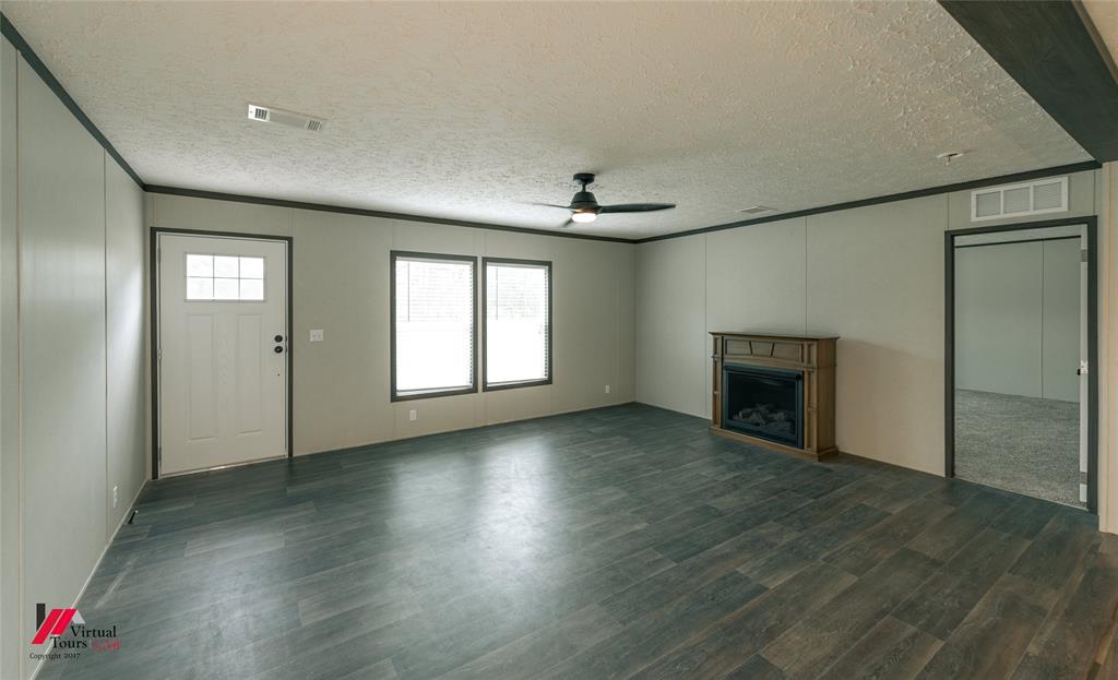 810 Chalybeate Springs Road Plain Dealing, LA 71064 - Photo 34 of 38 Front Living Room with Propane Freestanding Fireplace