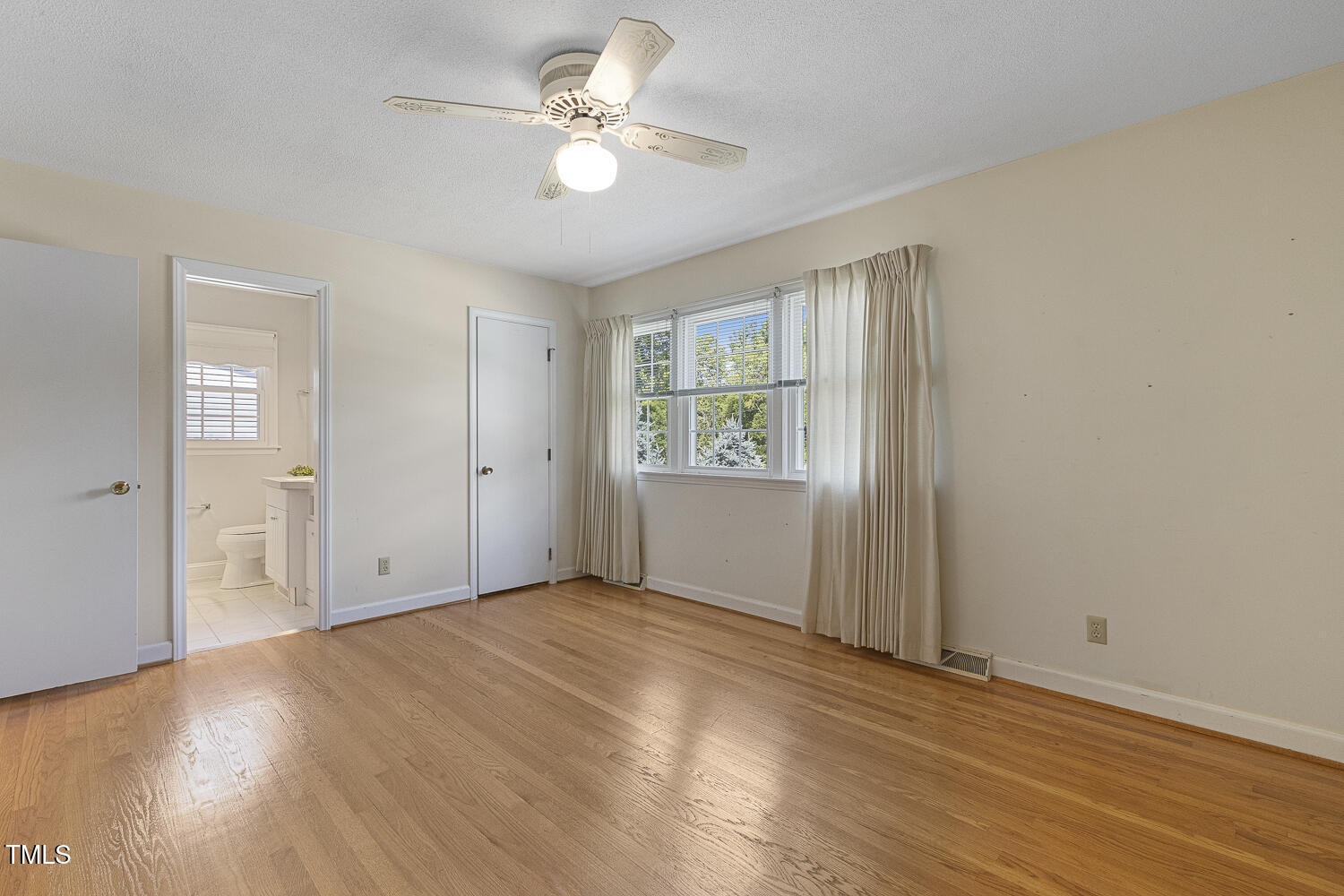1000 Winona Road Raleigh, NC 27609 - Photo 17 of 36 Primary bedroom with hardwood floors and walk-in closet