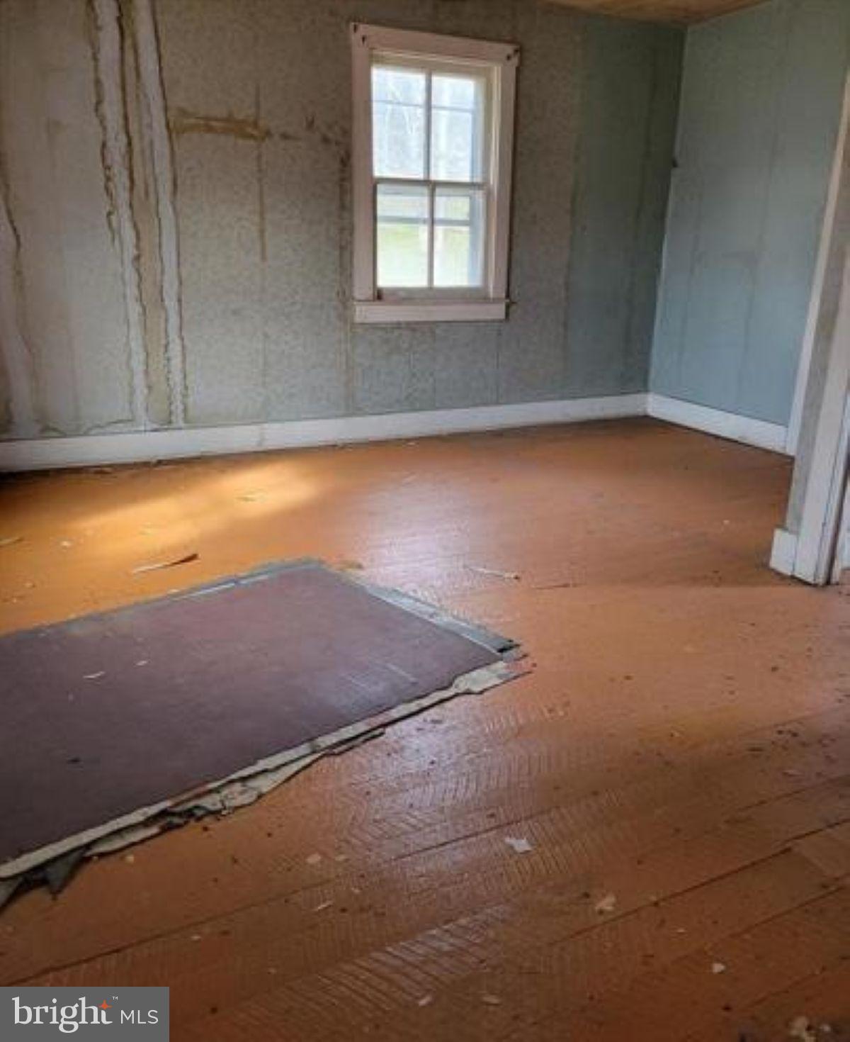 99 Little Cacapon Road Romney, WV 26757 - Photo 11 of 25 an empty room with a window