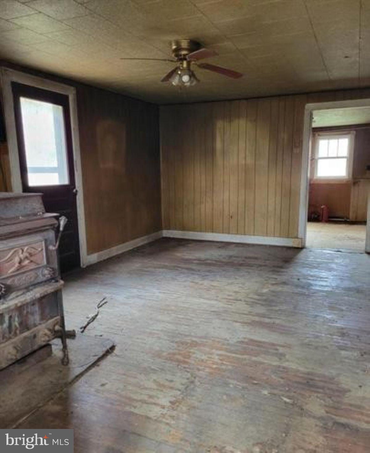 99 Little Cacapon Road Romney, WV 26757 - Photo 13 of 25 wooden floor in an empty room with a window