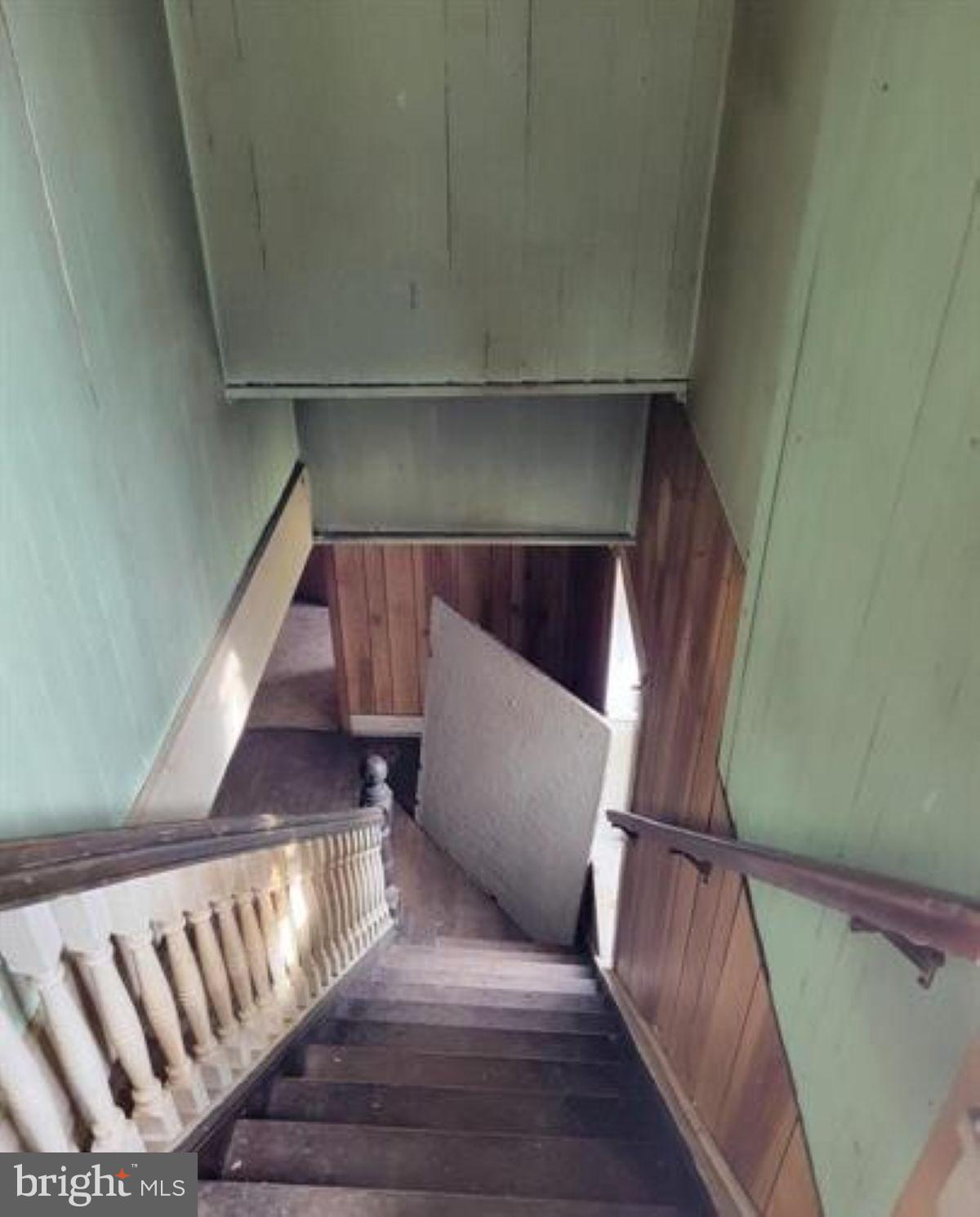 99 Little Cacapon Road Romney, WV 26757 - Photo 7 of 25 a view of staircase with wooden floor and chair