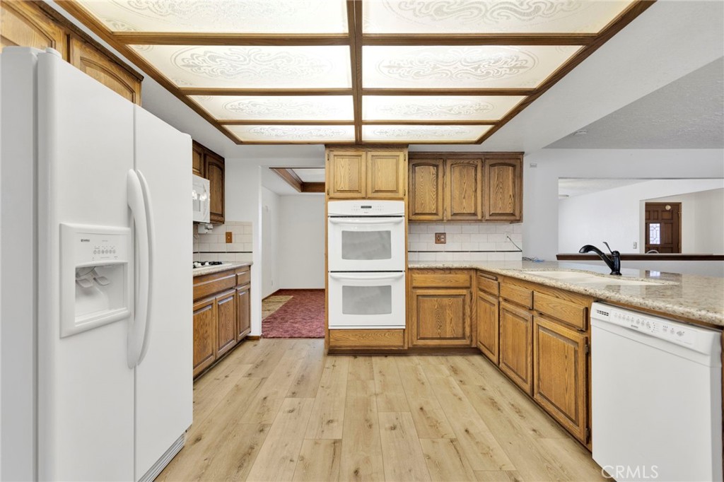 16224 Olalee Road Apple Valley, CA 92307 - Photo 11 of 48 a kitchen with stainless steel appliances a refrigerator and a sink