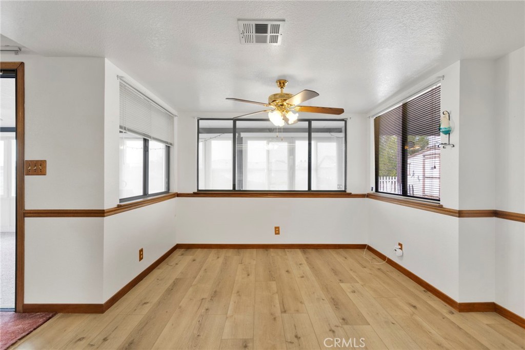 16224 Olalee Road Apple Valley, CA 92307 - Photo 13 of 48 wooden floor in an empty room with a window