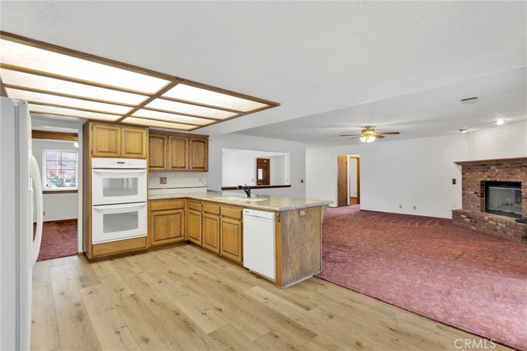 16224 Olalee Road Apple Valley, CA 92307 - Photo 14 of 48 a kitchen with stainless steel appliances granite countertop a stove and a refrigerator