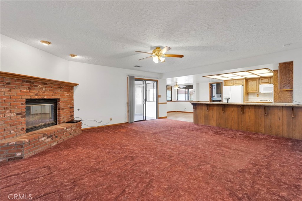 16224 Olalee Road Apple Valley, CA 92307 - Photo 18 of 48 a view of an empty room with a fireplace and a window