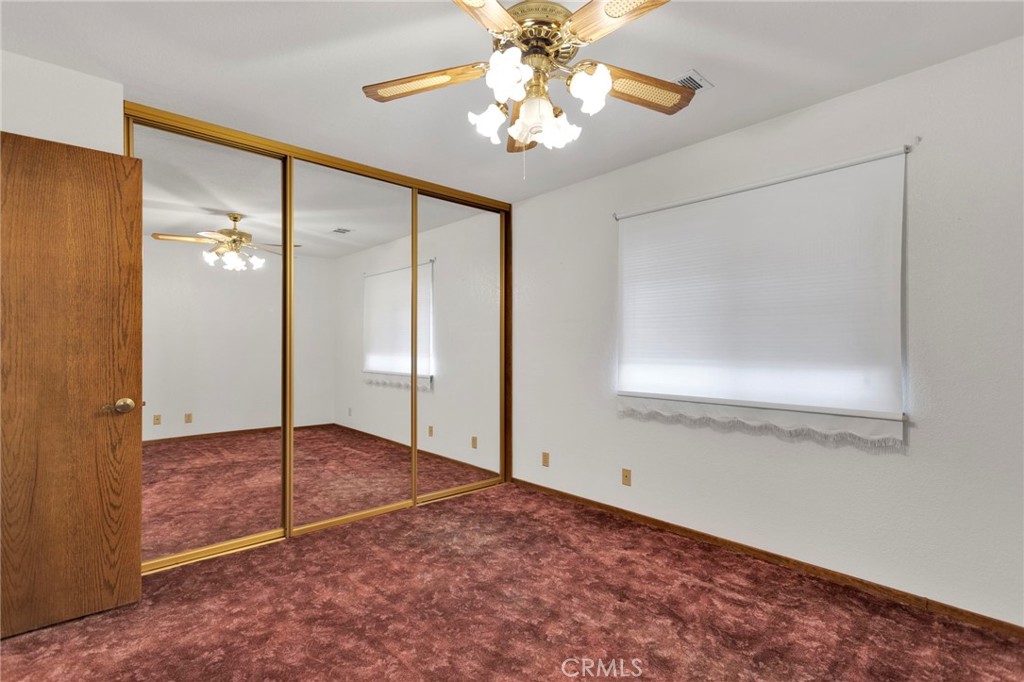 16224 Olalee Road Apple Valley, CA 92307 - Photo 20 of 48 an empty room with fan and entrance