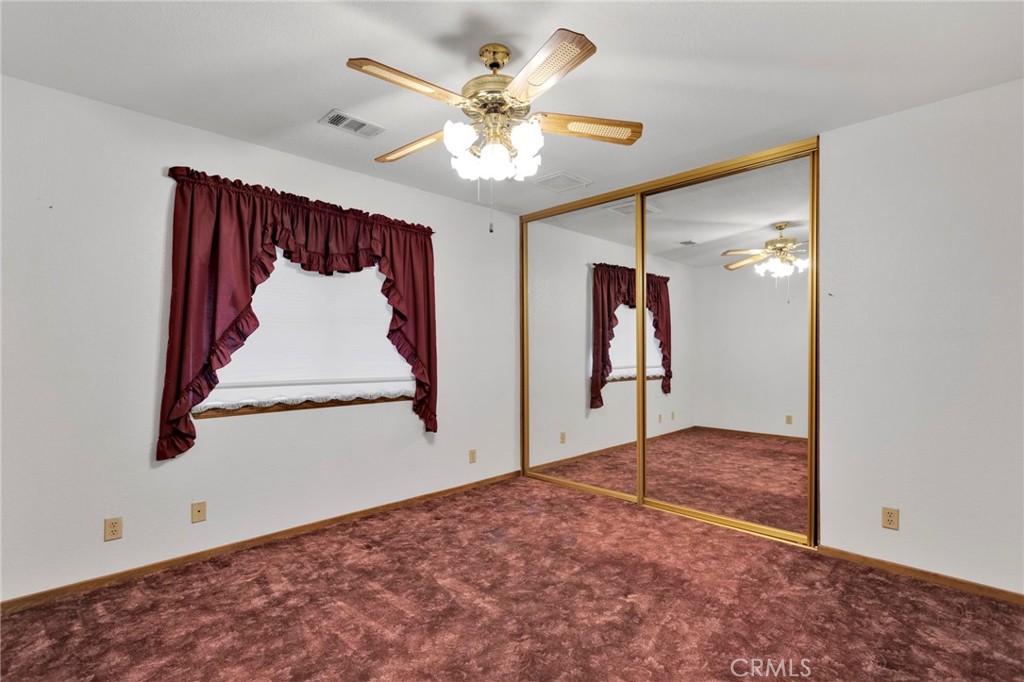 16224 Olalee Road Apple Valley, CA 92307 - Photo 21 of 48 a view of a hallway with a chandelier fan