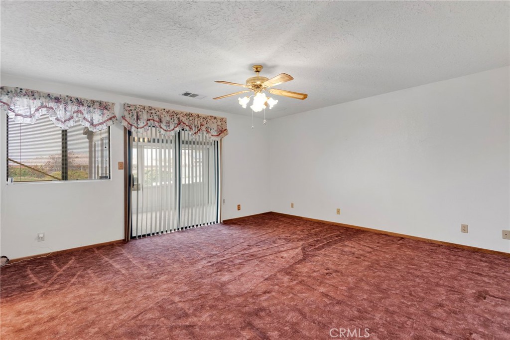 16224 Olalee Road Apple Valley, CA 92307 - Photo 23 of 48 a view of a big room with chandelier fan and windows
