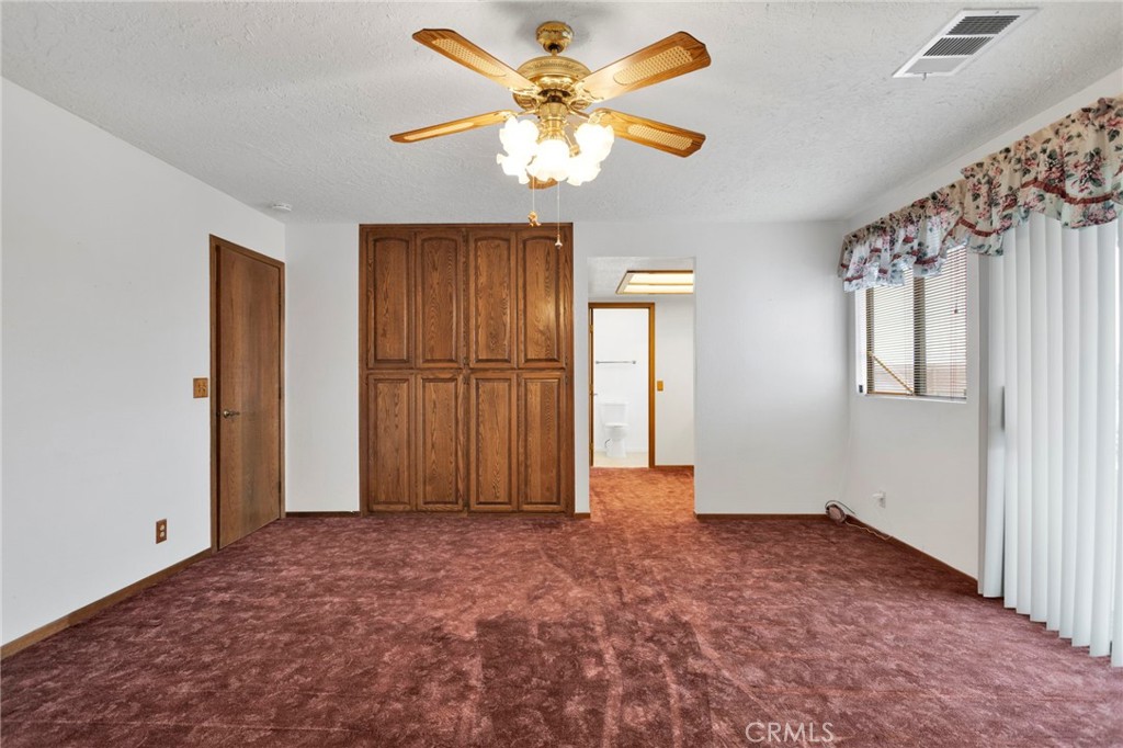 16224 Olalee Road Apple Valley, CA 92307 - Photo 24 of 48 wooden floor in an empty room with a chandelier fan