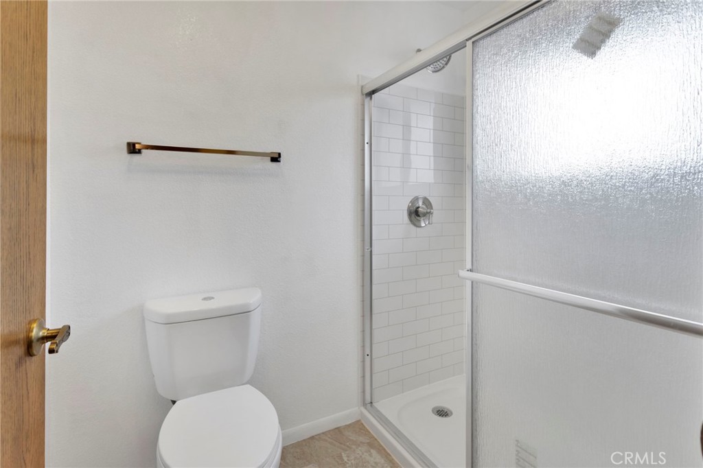 16224 Olalee Road Apple Valley, CA 92307 - Photo 27 of 48 a bathroom with a toilet and a shower