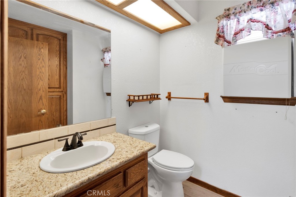 16224 Olalee Road Apple Valley, CA 92307 - Photo 30 of 48 a bathroom with a sink and a mirror