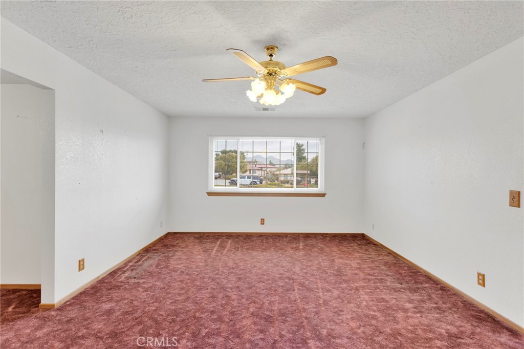 16224 Olalee Road Apple Valley, CA 92307 - Photo 6 of 48 an empty room with windows and fan