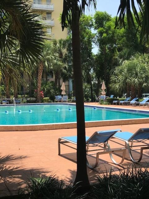Yolanda Villas Condominiums Miami, FL 33126 - Photo 12 of 13 a view of a lake with a bench and trees