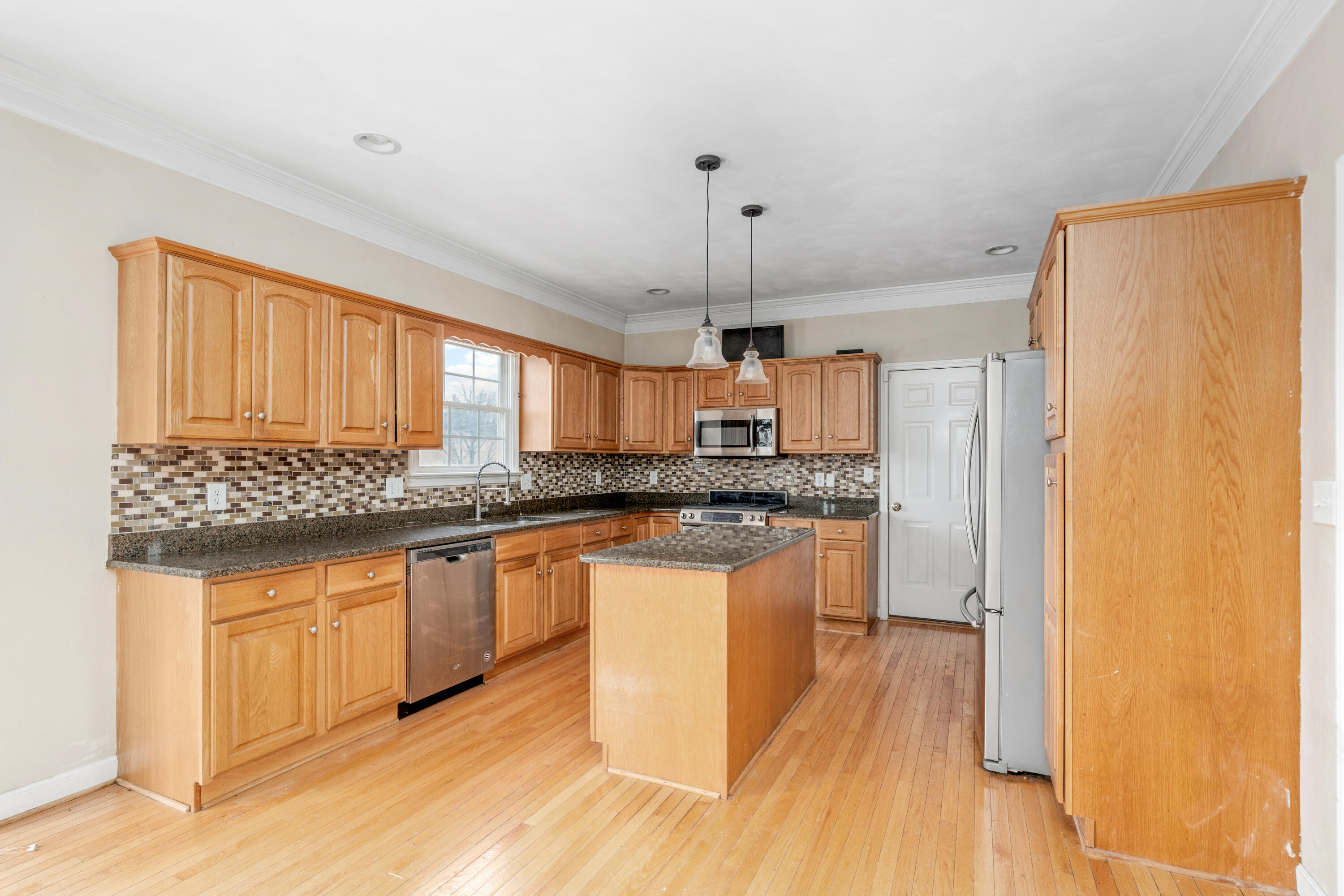 765 Country Club Road Troutville, VA 24175 - Photo 12 of 29 a kitchen with stainless steel appliances granite countertop a sink cabinets and wooden floor