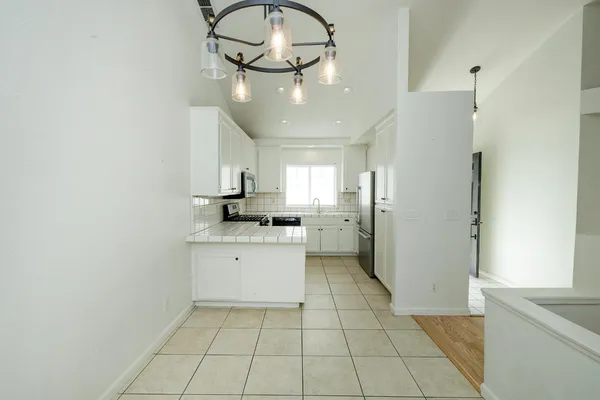 a kitchen with a refrigerator a sink and cabinets