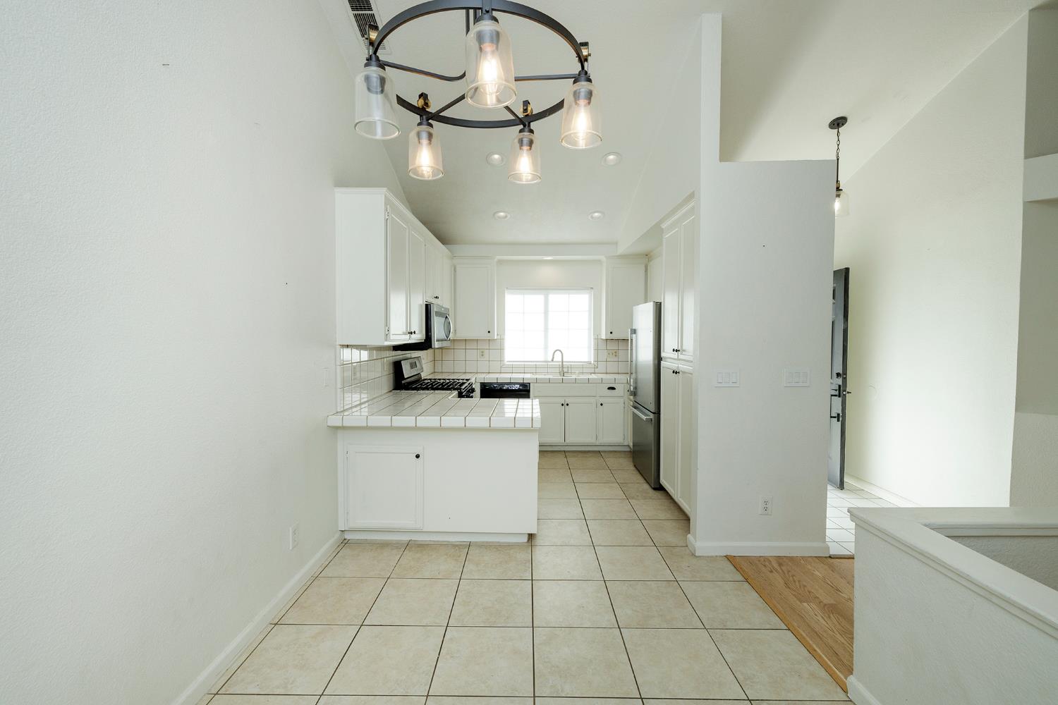 4093 Heartland Way Turlock, CA 95382 - Photo 12 of 43 a kitchen with stainless steel appliances a refrigerator and microwave