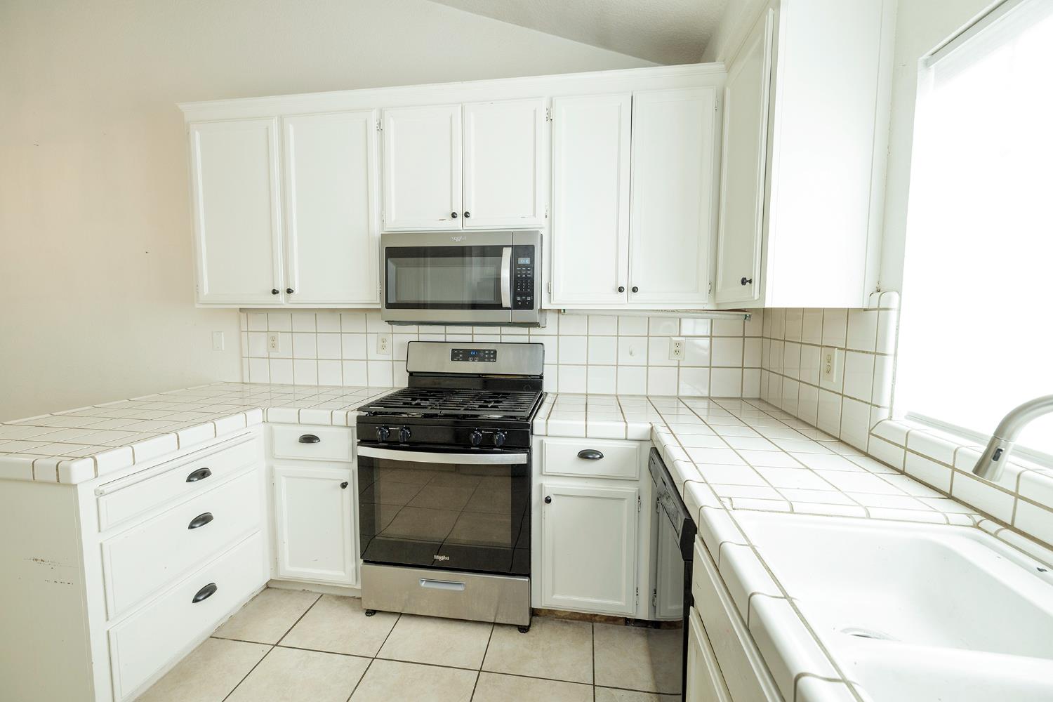 4093 Heartland Way Turlock, CA 95382 - Photo 17 of 43 a kitchen with cabinets appliances and sink