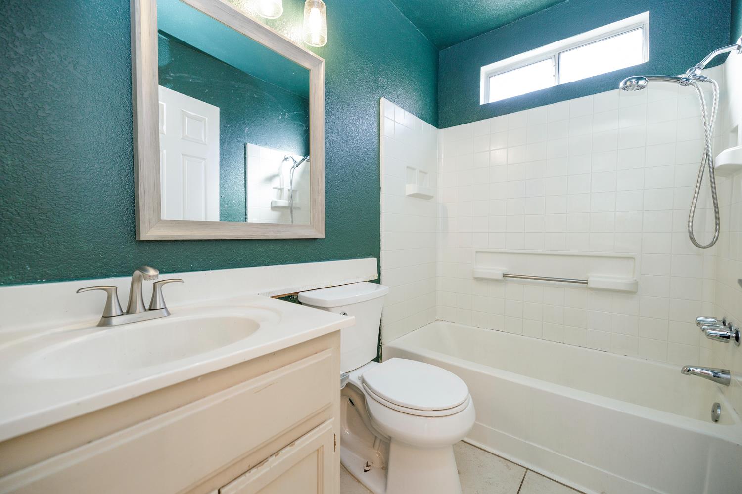 4093 Heartland Way Turlock, CA 95382 - Photo 27 of 43 a bathroom with a sink a toilet and shower