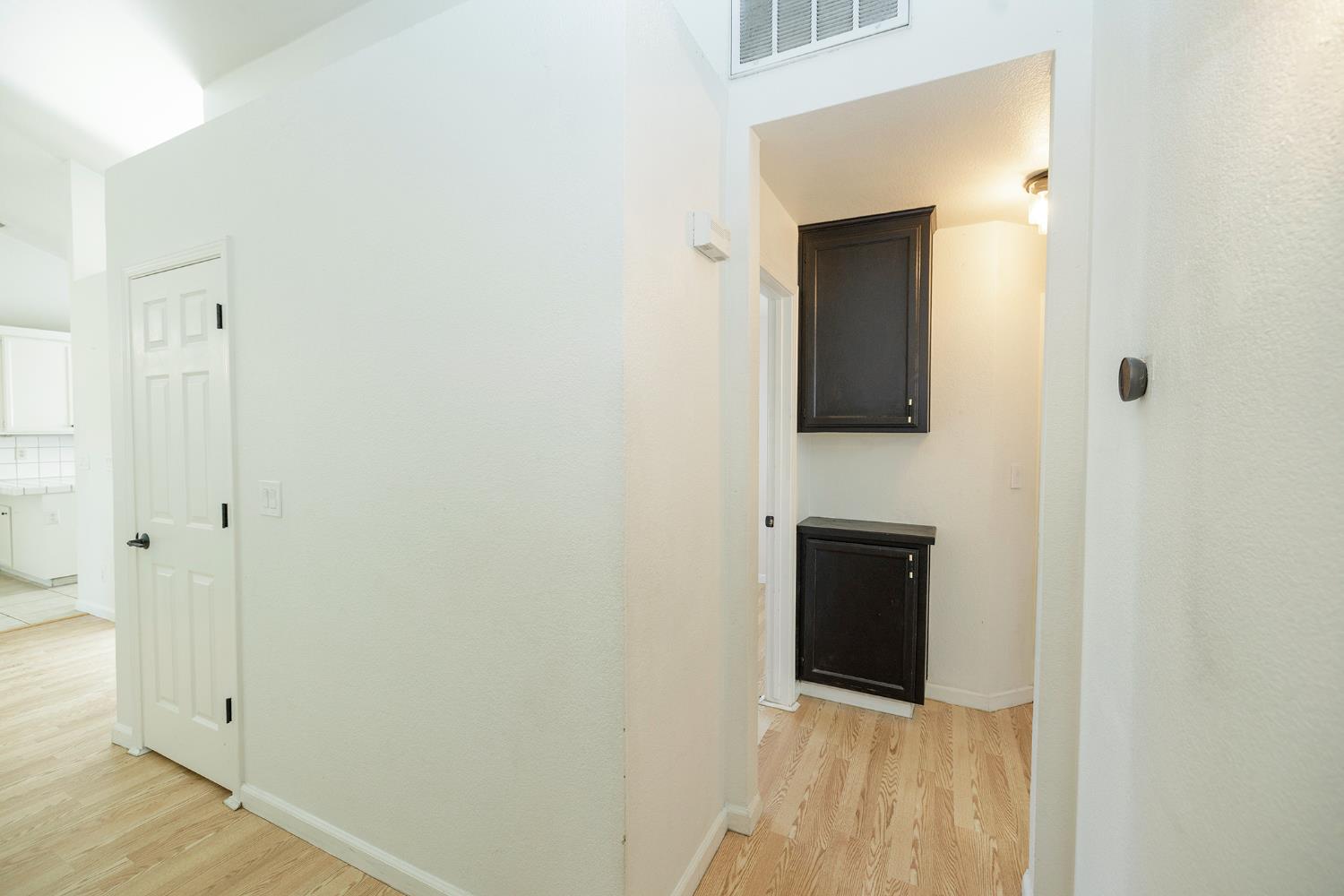 4093 Heartland Way Turlock, CA 95382 - Photo 31 of 43 a view of a hallway with wooden floor