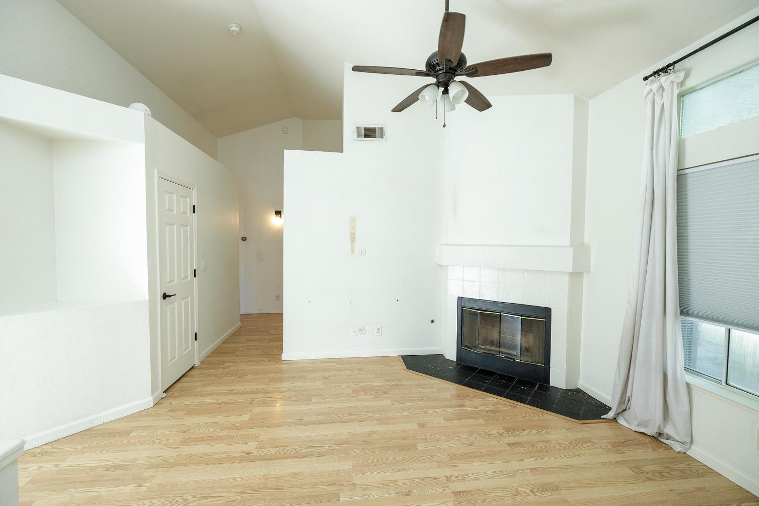 4093 Heartland Way Turlock, CA 95382 - Photo 6 of 43 a view of empty room with fireplace and a ceiling fan