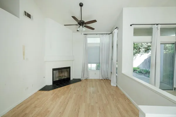 a view of empty room with wooden floor