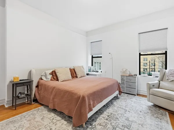 a bedroom with a bed and a couch