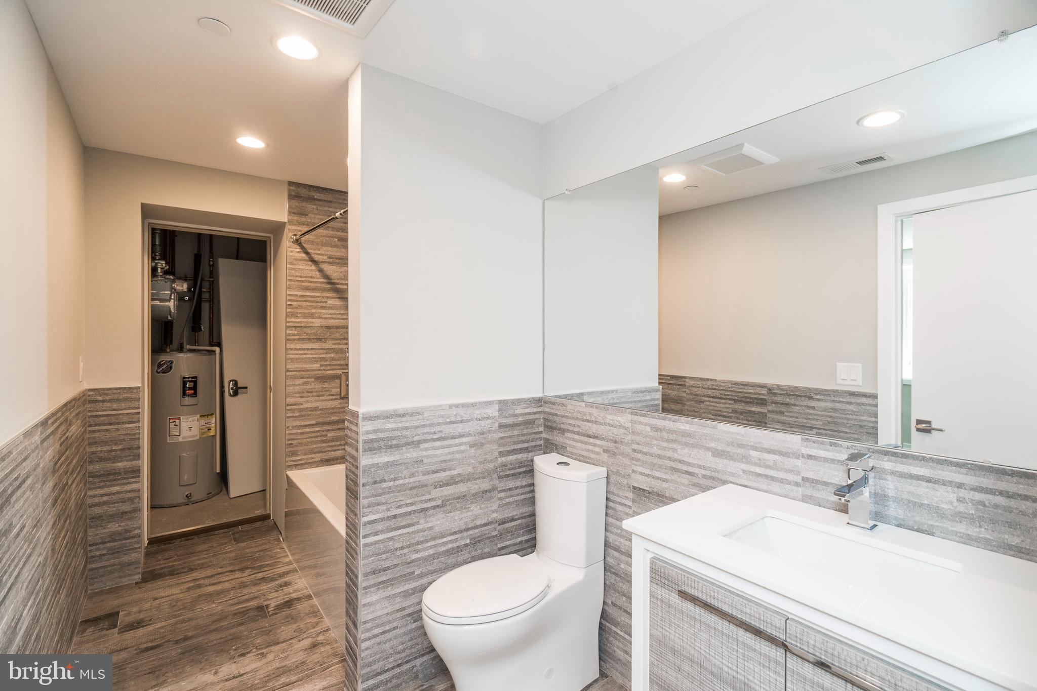 1701 Bainbridge Street, Unit 1 Philadelphia, PA 19146 - Photo 12 of 20 a bathroom with a granite countertop sink toilet and shower