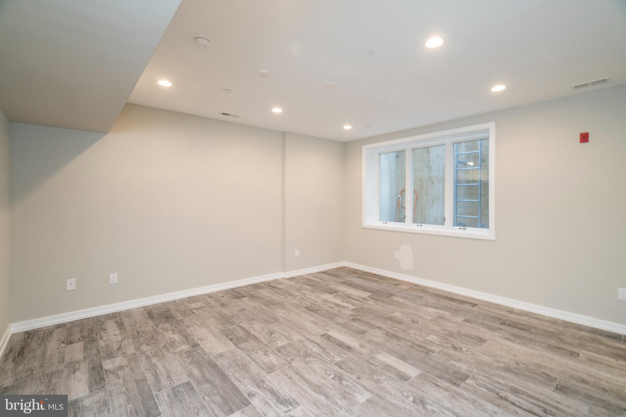 1701 Bainbridge Street, Unit 1 Philadelphia, PA 19146 - Photo 19 of 20 an empty room with wooden floor and windows