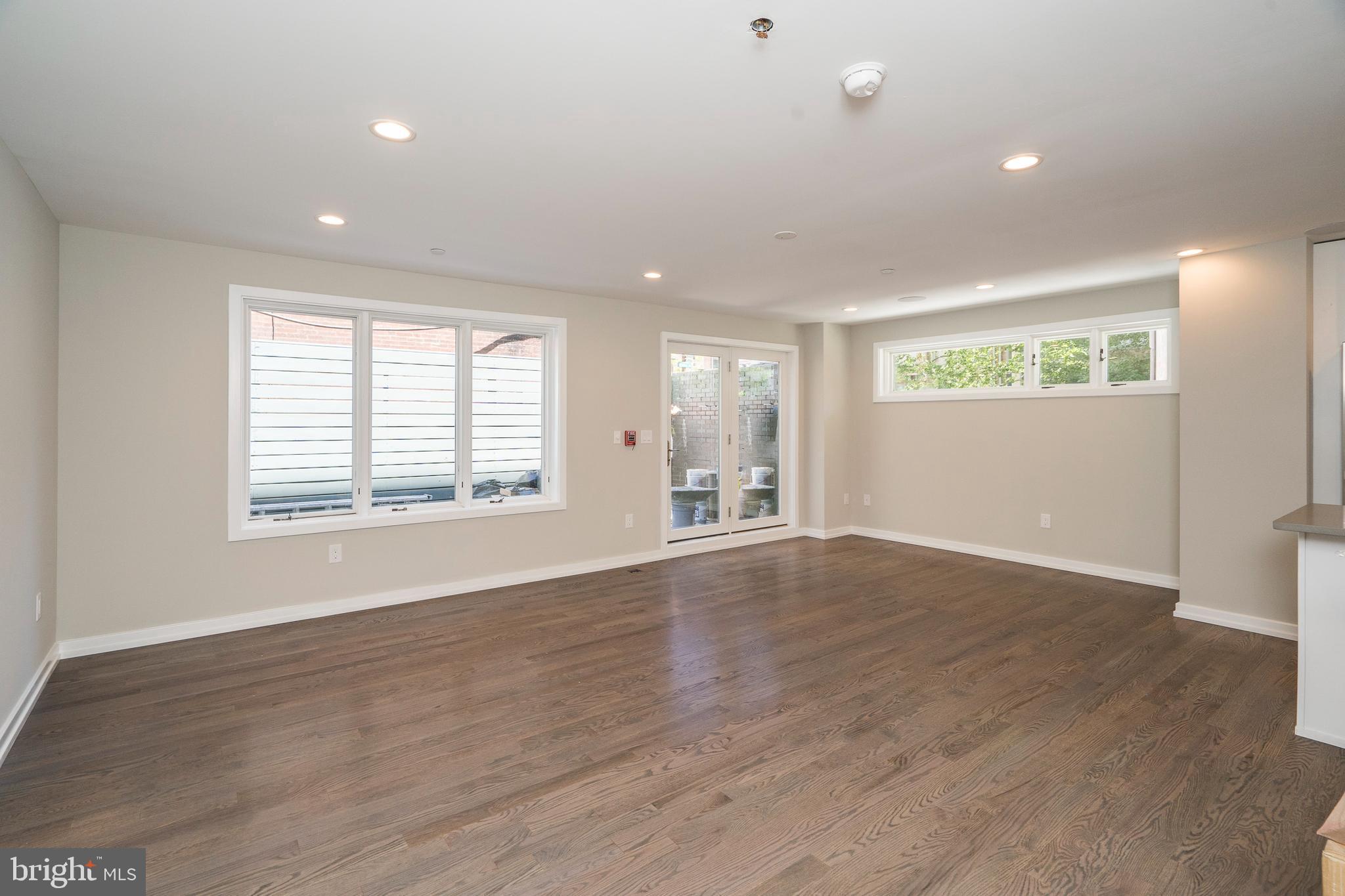 1701 Bainbridge Street, Unit 1 Philadelphia, PA 19146 - Photo 4 of 20 a view of an empty room with wooden floor and a window