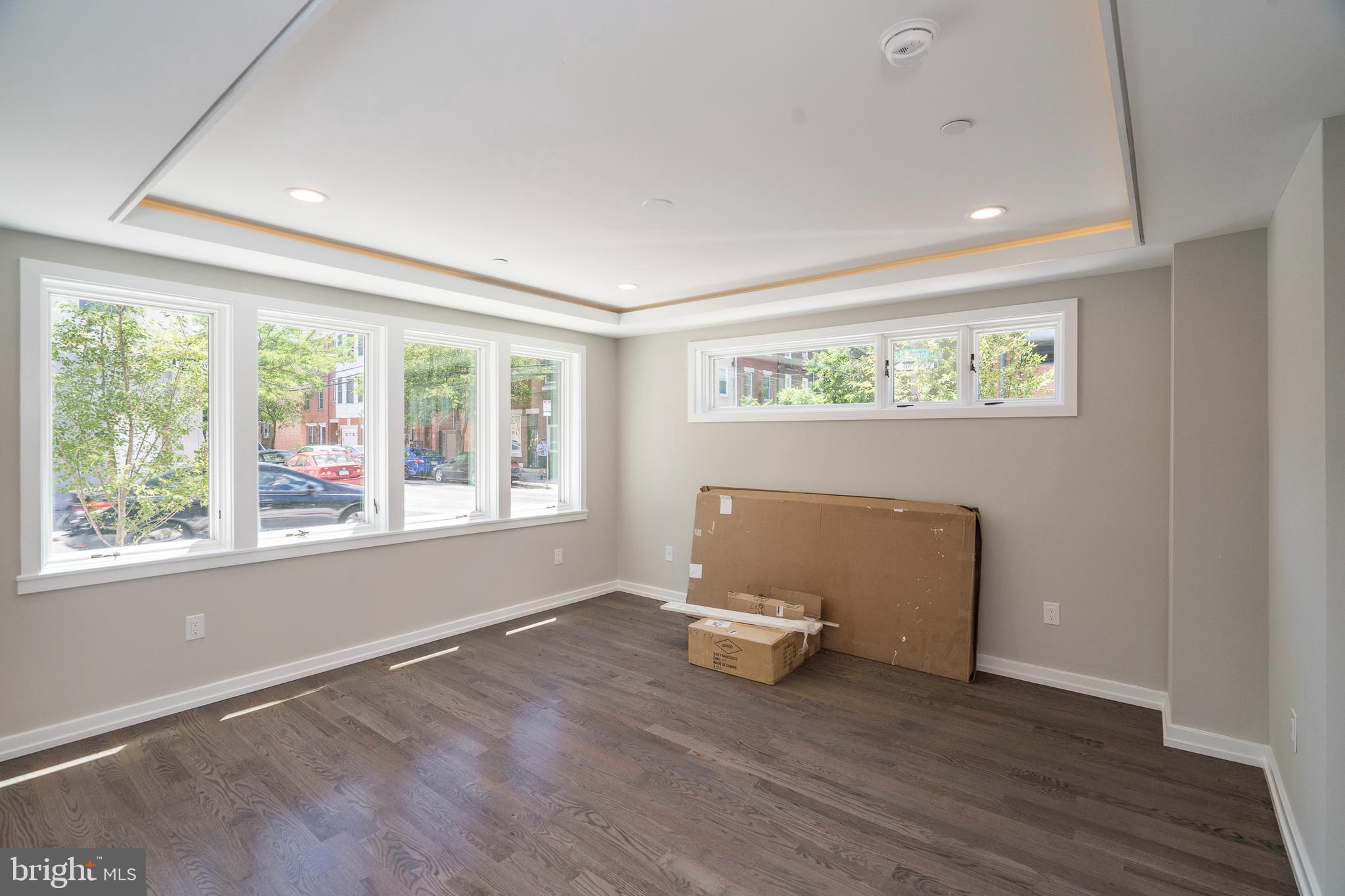 1701 Bainbridge Street, Unit 1 Philadelphia, PA 19146 - Photo 6 of 20 a view of an empty room with wooden floor and a window