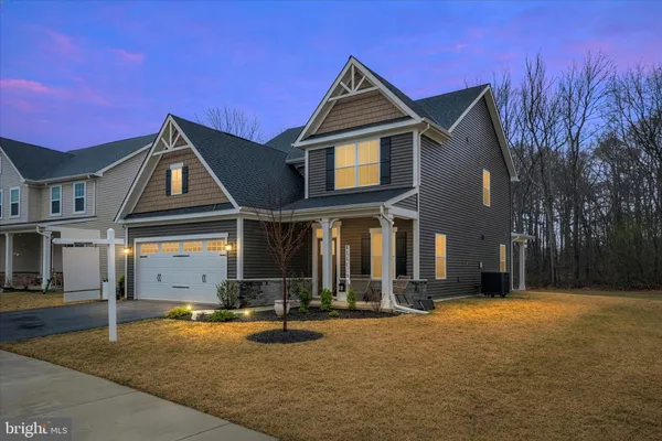 a front view of a house with basket ball court and a fire pit