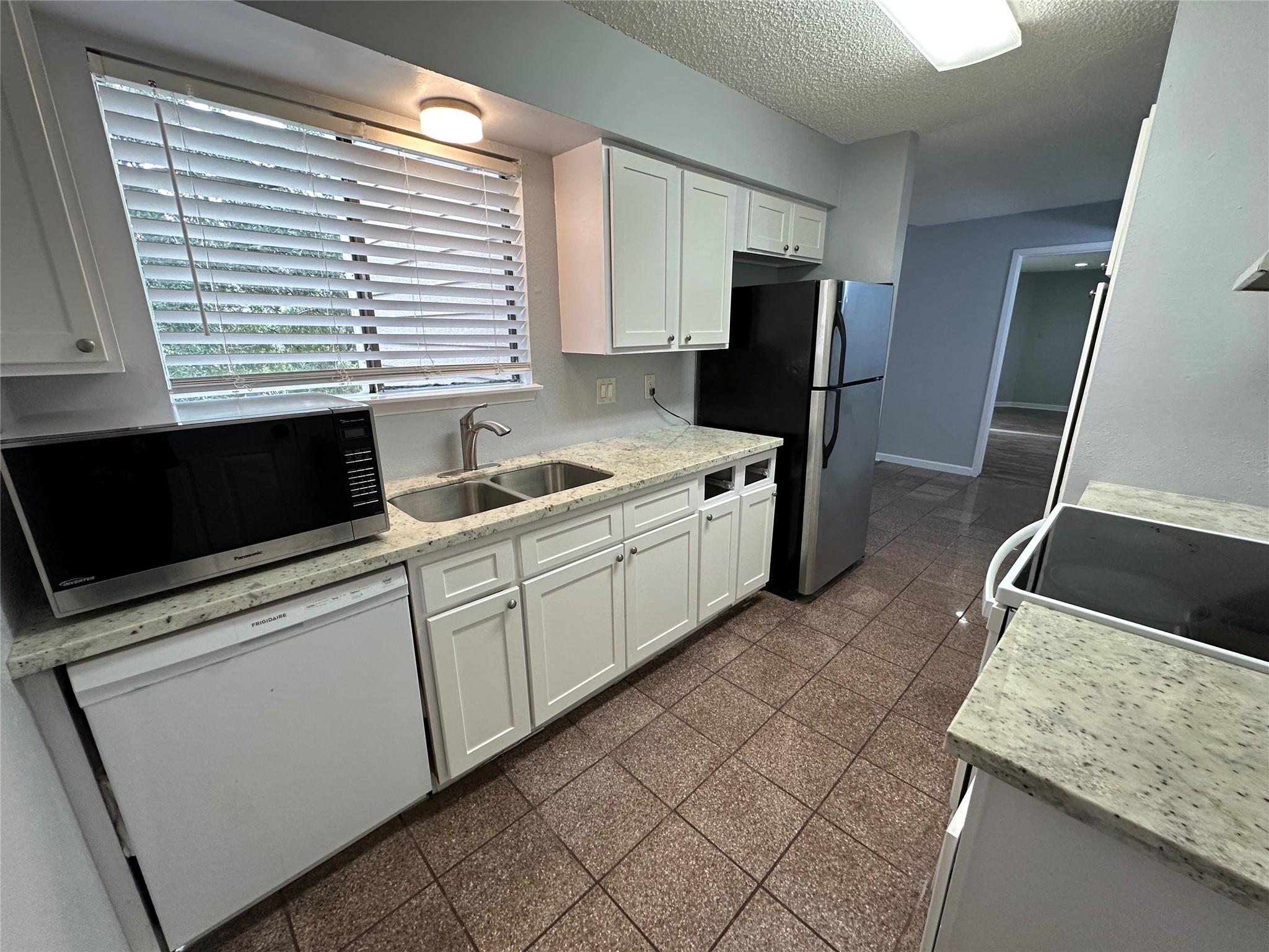 6701 Sands Point Drive, Unit 66 Houston, TX 77074 - Photo 14 of 19 a kitchen with a sink and a refrigerator