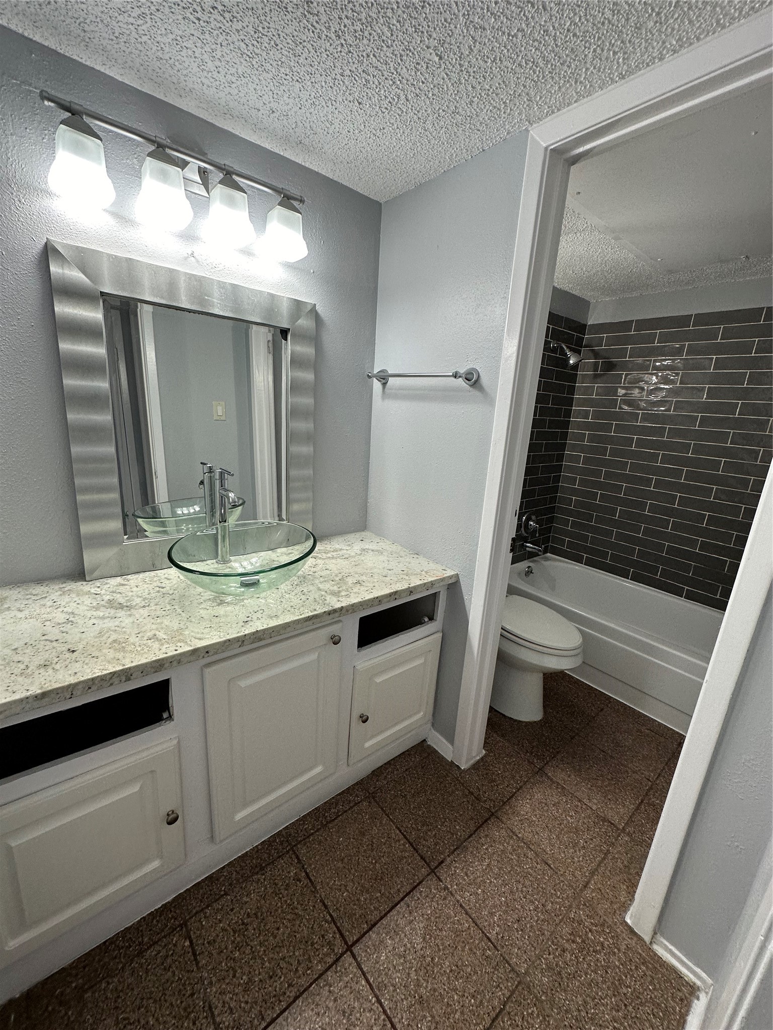 6701 Sands Point Drive, Unit 66 Houston, TX 77074 - Photo 17 of 19 a bathroom with a granite countertop sink and a mirror