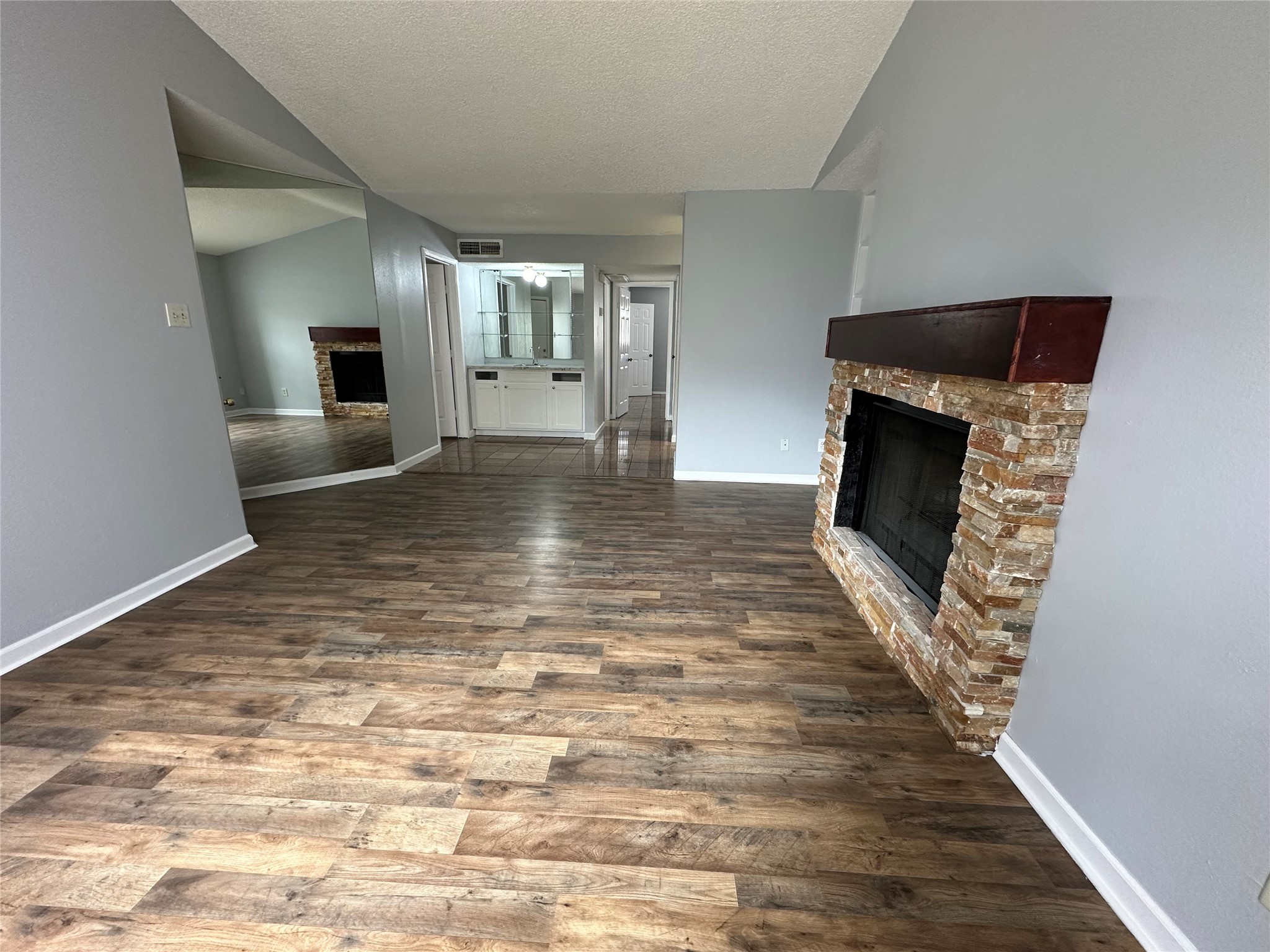 6701 Sands Point Drive, Unit 66 Houston, TX 77074 - Photo 2 of 19 a view of empty room with wooden floor and fireplace