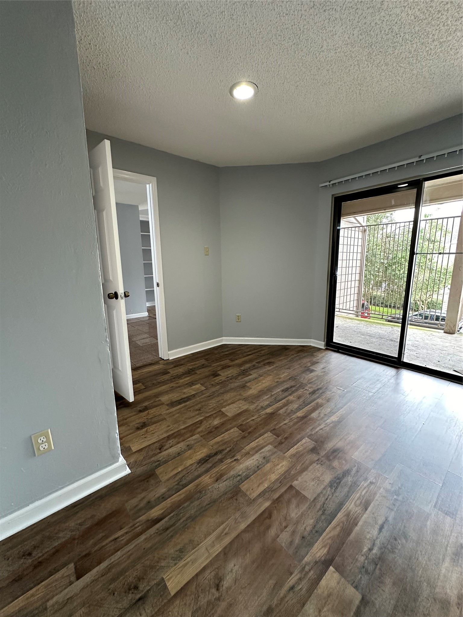6701 Sands Point Drive, Unit 66 Houston, TX 77074 - Photo 4 of 19 an empty room with wooden floor and windows