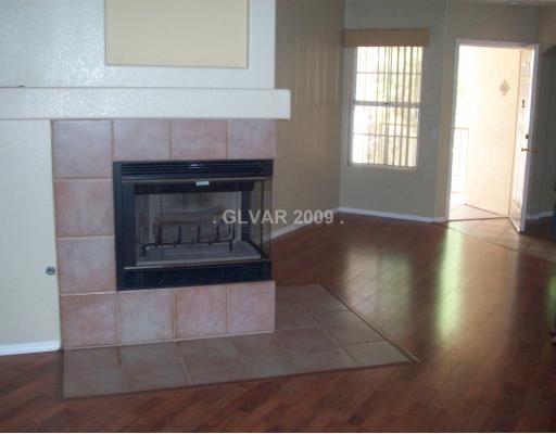 7400 West Flamingo Road, Unit 2054 Las Vegas, NV 89147 - Photo 2 of 4 Living Room. Hardwood Floors, 2 way fireplace, 2 tone paint, upgrades window treatments