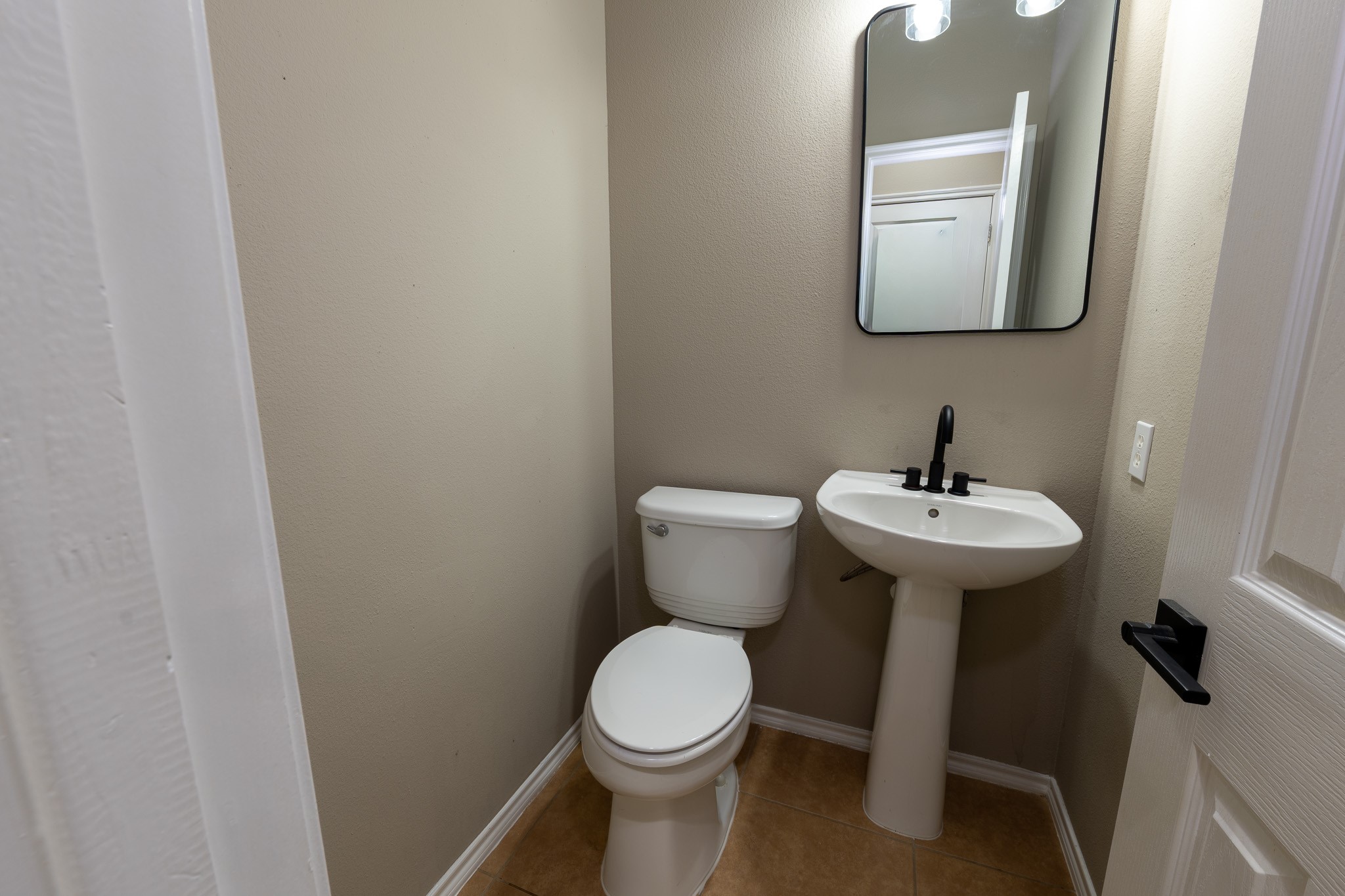 13600 Breton Ridge Street, Unit 35C Houston, TX 77070 - Photo 14 of 35 a bathroom with a toilet sink and mirror