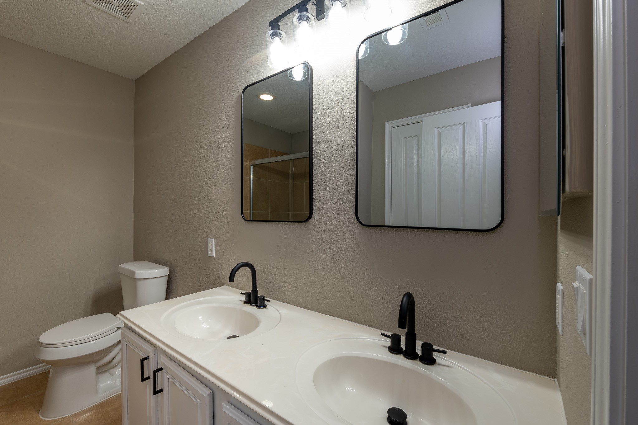13600 Breton Ridge Street, Unit 35C Houston, TX 77070 - Photo 21 of 35 a bathroom with a toilet sink and mirror