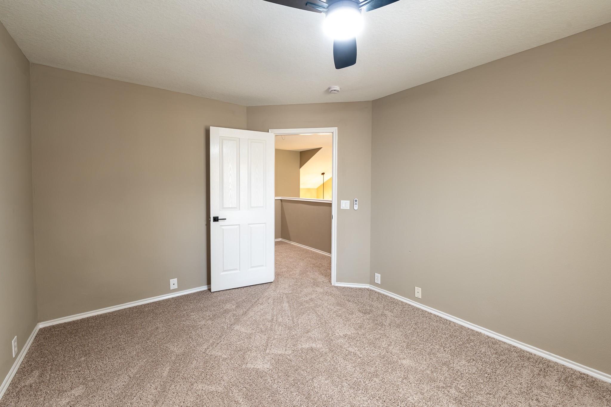 13600 Breton Ridge Street, Unit 35C Houston, TX 77070 - Photo 27 of 35 an empty room with chandelier fan and windows