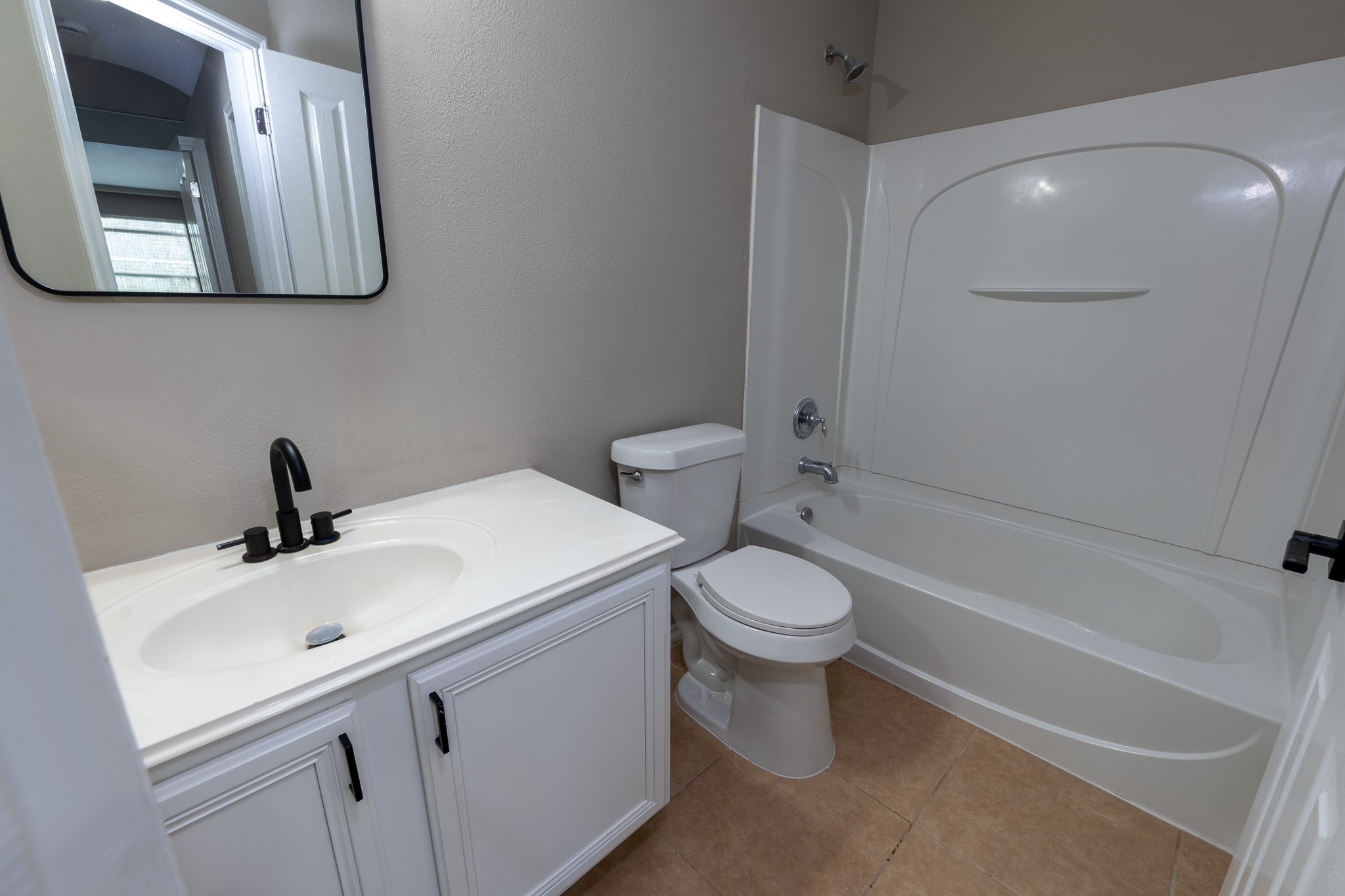 13600 Breton Ridge Street, Unit 35C Houston, TX 77070 - Photo 28 of 35 a bathroom with a toilet sink and mirror